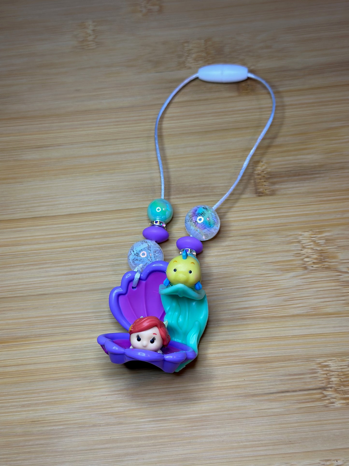 A LITTLE MERMAID AND A GUPPY CAR CHARM...