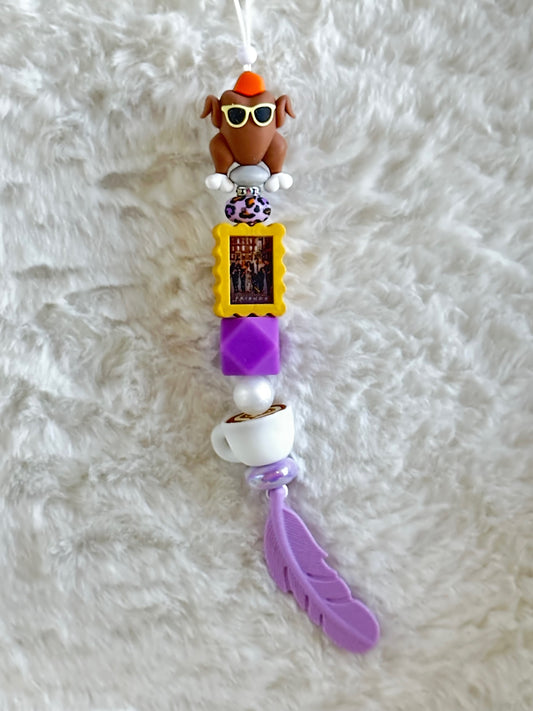 THE ONE THAT YOU PUT ON REAR VIEW MIRROR CAR CHARM...