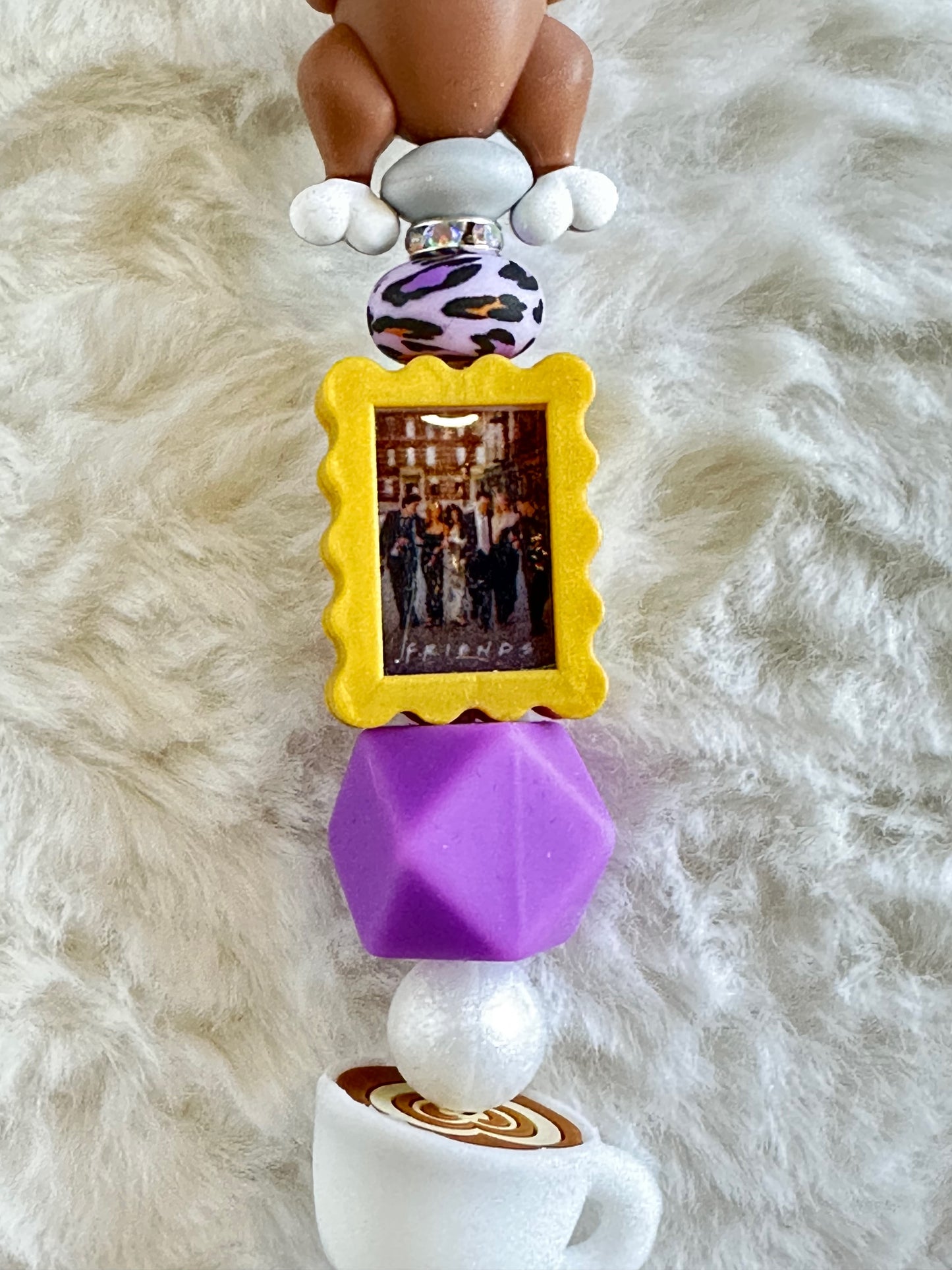 THE ONE THAT YOU PUT ON REAR VIEW MIRROR CAR CHARM...